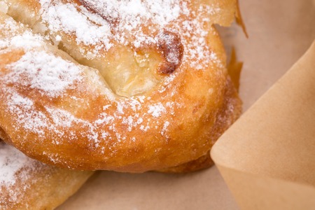 Closeup of heat apple puff cake in cardboard box. Macro. Can be used as a whole background.の写真素材