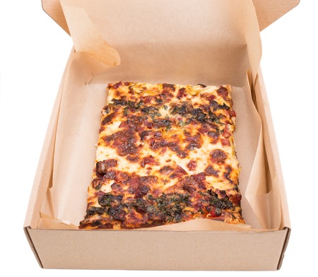 Heat american pizza in cardboard box. Isolated on a white background.の写真素材