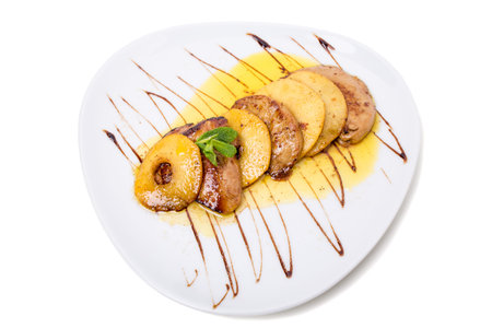 Pork tenderloin with grilled pineapple with delicious sauce and fresh mint. Isolated on a white background.の写真素材