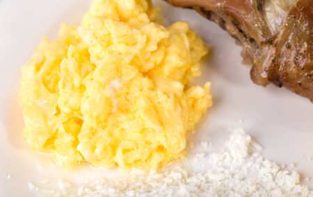 Scrambled eggs with grated cheese and grilled pork meat. Macro. Photo can be used as a whole background.の写真素材
