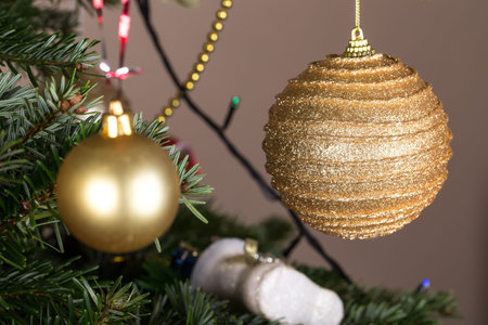 Christmas golden ball on pine tree as a decoration. Macro. Can be used as a whole background.