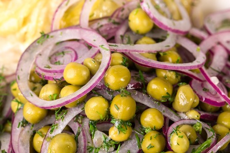 Marinated green peas with sliced red onion and fresh dill. Macro. Can be used as a whole background.の写真素材