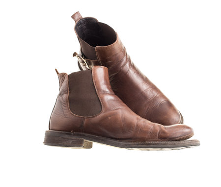 Stylish old chelsea leather boots. Isolated on a white background