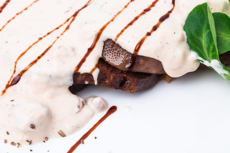 Delicious roasted veal tongue covered with mushroom sauce. Macro. Photo can be used as a whole background.の写真素材