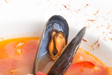 Spicy tomato seafood soup with saffron and paprika. Macro. Photo can be used as a whole background.の写真素材