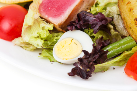 Classic nicoise salad with roasted potatoes and grilled tuna. Macro. Photo can be used as a whole background.の写真素材