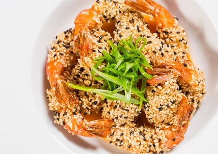 Delicious grilled jumbo shrimps with sesame and sliced scallions. Macro. Photo can be used as a whole background.の写真素材