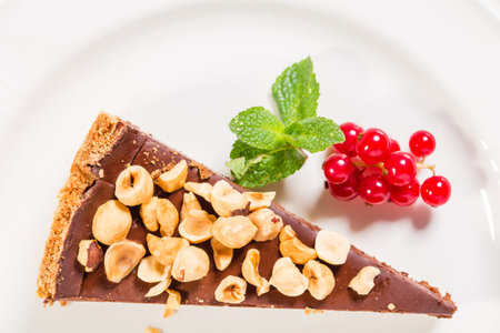 Chocolate cheesecake with hazelnuts and red currant. Macro. Photo can be used as a whole background.の写真素材