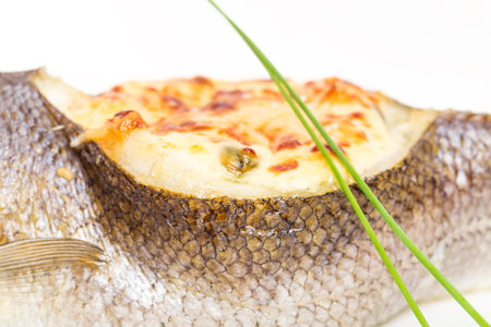 Baked sea bass stuffed with seafood and cheese. Macro. Photo can be used as a whole background.