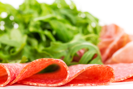 Delicious italian salami with heap of arugula. Macro. Photo can be used as a whole background.の写真素材