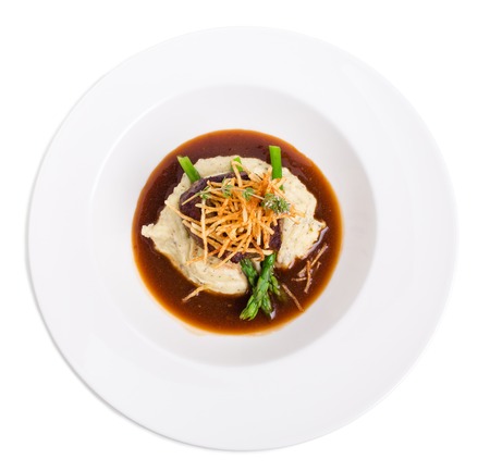Delicious tenderloin steak with asparagus and french fries on potato puree. Isolated on a white background.の写真素材