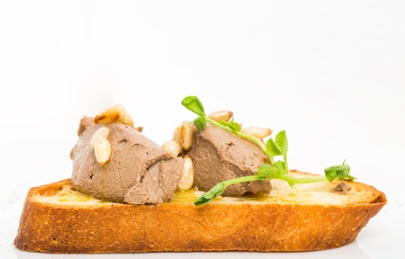 Delicious bruschetta with chicken liver pate and pine nuts. Macro. Photo can be used as a whole background.の写真素材
