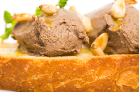 Delicious bruschetta with chicken liver pate and pine nuts. Macro. Photo can be used as a whole background.の写真素材