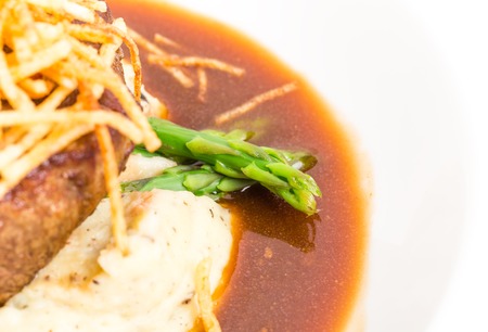 Delicious tenderloin steak with asparagus and french fries on potato puree. Macro. Photo can be used as a whole background.の写真素材
