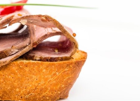 Delicious italian bruschetta with roast beef and fresh scallions. Macro. Photo can be used as a whole background.の写真素材