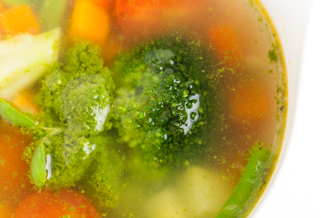 Bowl of minestrone soup with pesto. Focus on broccoli. Macro. Photo can be used as a whole background.の写真素材