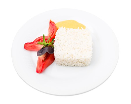 Delicious basmati rice with herbs and tomatoes. Isolated on a white background.の写真素材
