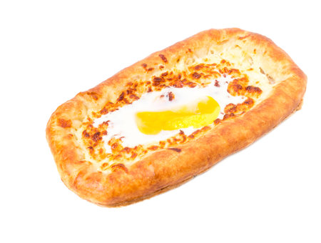Traditional georgian cheese-filled pie Khachapuri with chicken eggs. Isolated on a white background.の写真素材