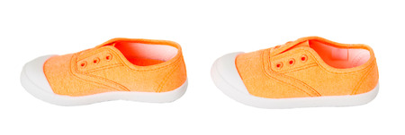 Baby girl orange fabric sneakers. Isolated on a white background.の写真素材