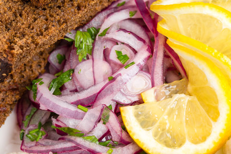 Grilled bread and marinated red onion as a garnish for herring fillet. Macro. Photo can be used as a whole background.の写真素材