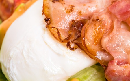 Warm bacon salad with mozzarella and tomatoes. Served with grilled toasts. Macro. Photo can be used as a whole background.の写真素材