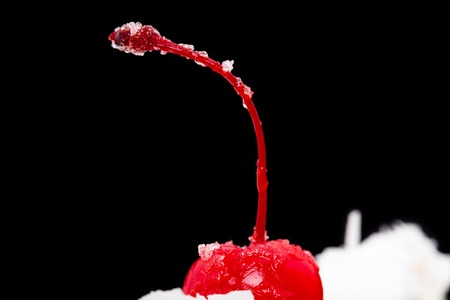 Cocktail cherry on top of delicious cake. Macro. Photo can be used as a whole background.の写真素材