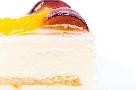 Creamy yougurt mousse cake with fruits on top. Macro. Photo can be used as a whole background.の写真素材