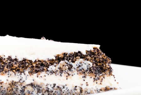 Delicious poppy seed cake with walnuts. Macro. Located against black background.の写真素材