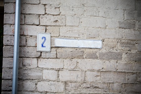 House number plate on a brick wall. Photo can be used as a whole background.の写真素材