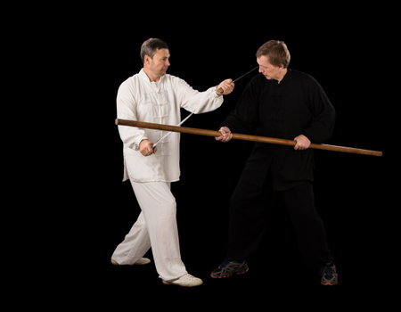 Men fighting martial arts on a black background