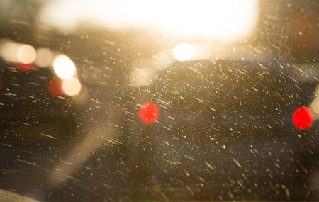 Selective focud on dusty windshield closeup and defocused cars as a whole background.の写真素材