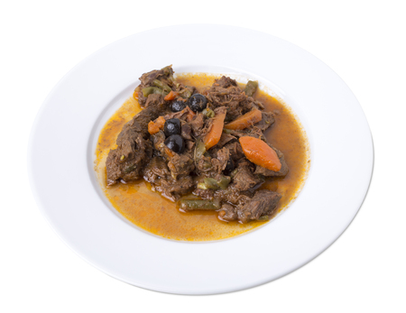 Closeup of a beef ragout serve on a round plate. Isolated on a white background.の写真素材