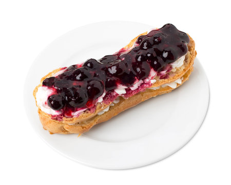 Delicious eclair with berry jam. Isolated on a white background.