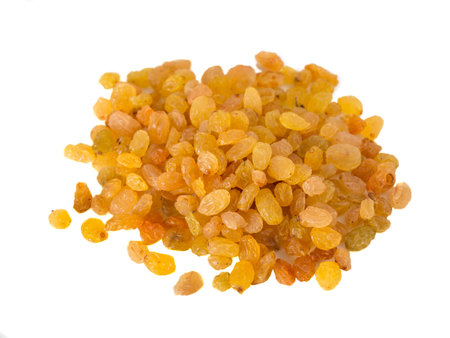 Heap of yellow raisins. Isolated on a white background.の写真素材