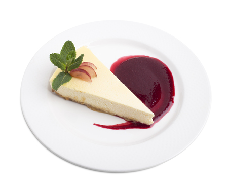 Delicious cheesecake with raspberry jam and mint.  Isolated on a white background.の写真素材