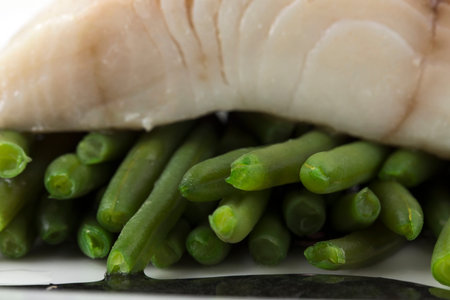 Steamed trout fillet with french beans. Macro. Photo can be used as a whole background.