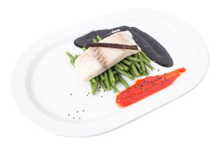 Steamed trout fillet with french beans and delicious sauces. Isolated on a white background.