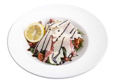 Arugula salad with prosciutto and parmesan. Isolated on a white background.の写真素材