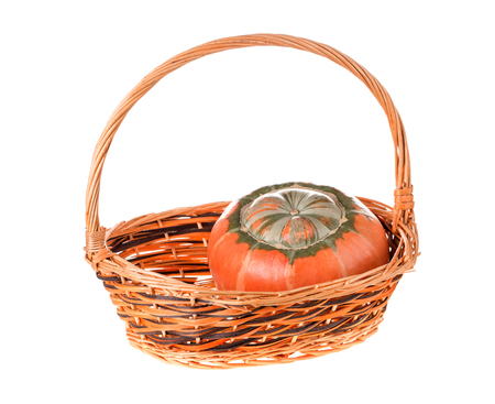 Composition of a pumpkin at the basket. Isolated on the white background.の写真素材