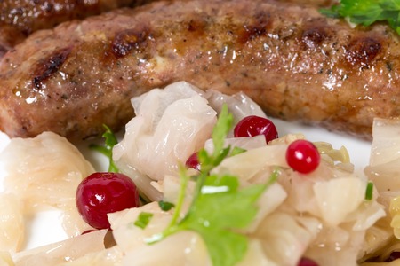 Grilled sausages with sauerkraut and mustard. Macro. Photo can be used as a whole background.の写真素材