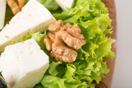 Georgian cheese platter with grapes and walnuts. Macro. Photo can be used as a whole background.の写真素材