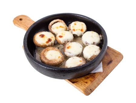 Baked mushrooms with cheese on frying pan. Isolated on a white background.の写真素材