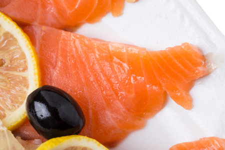 Delicious salmon fillet with lemons and olives. Macro. Photo can be used as a whole background.の写真素材