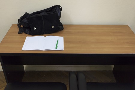 Desktop in the office. There are a notebook and a pen on the desktop.の写真素材