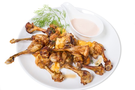 Chicken legs with melted cheese and delicious sauce. Isolated on a white background.の写真素材