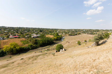 View on the village. River near a village and stonefield.