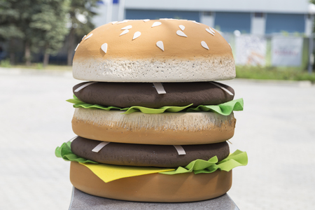 Big artificial burger is made with a love. It is located in the street as advertising material. Close-up.の写真素材