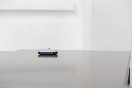 Mobile smart phone is located on the table. New technology in our life.の写真素材