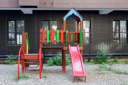 Modern courtyard in the new housing building. Colourful playground for children in public housing...