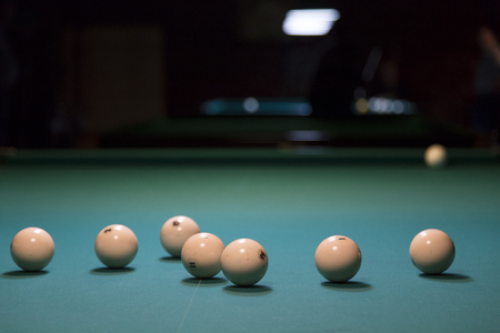 Ivoye balls and green table for russian billierd. Russian billiard have a name Pyramid.の写真素材